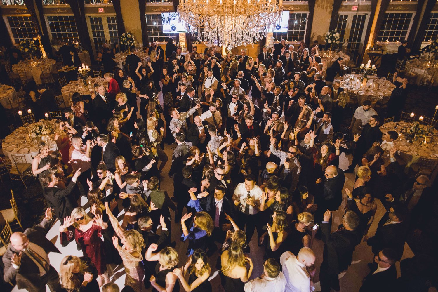 Full ballroom dancefloor under a crystal chandelier
