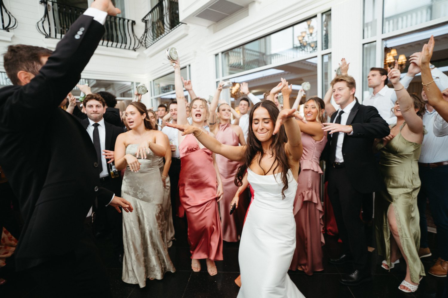 Bride dancing surrounded by her bridal party