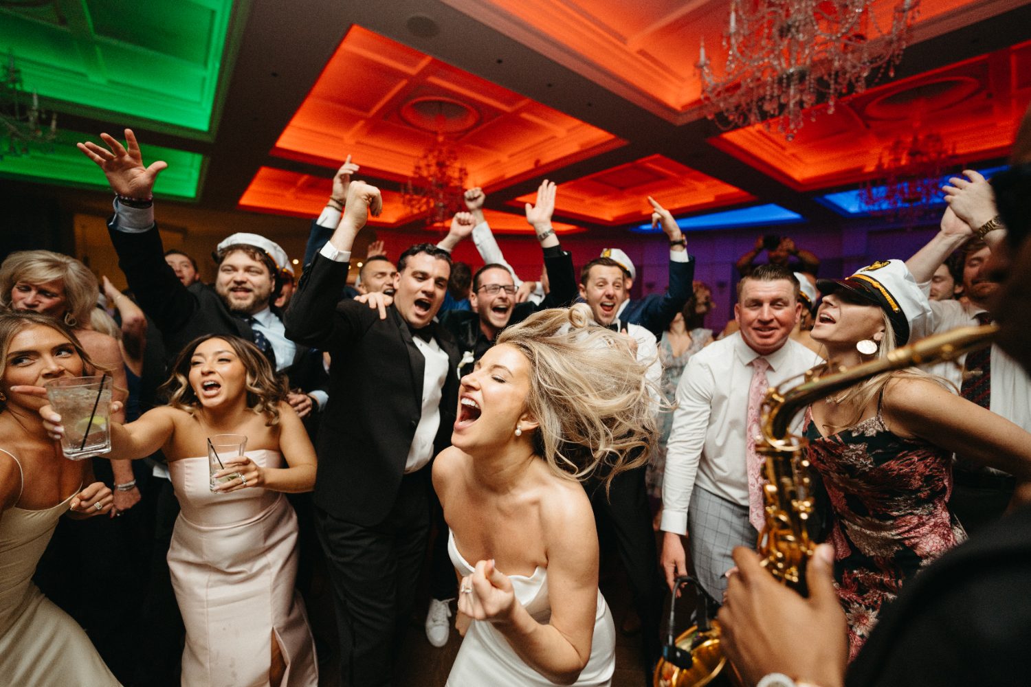 Bride singing on the floor beside a live saxophone player