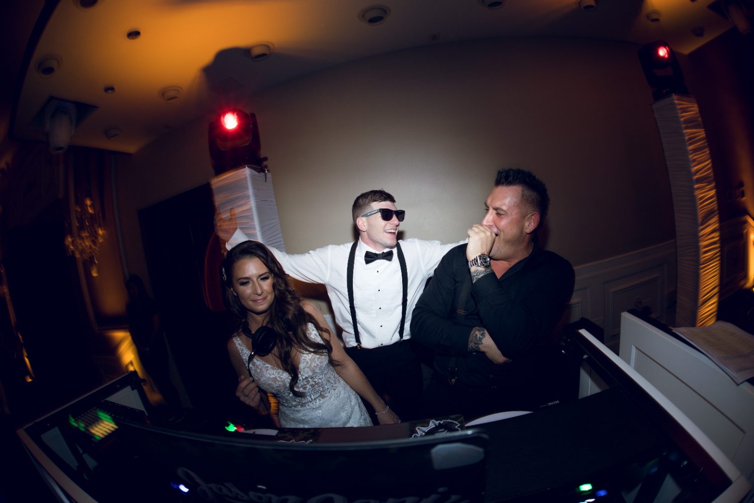 A bride and groom behind the decks with Jason Jani
