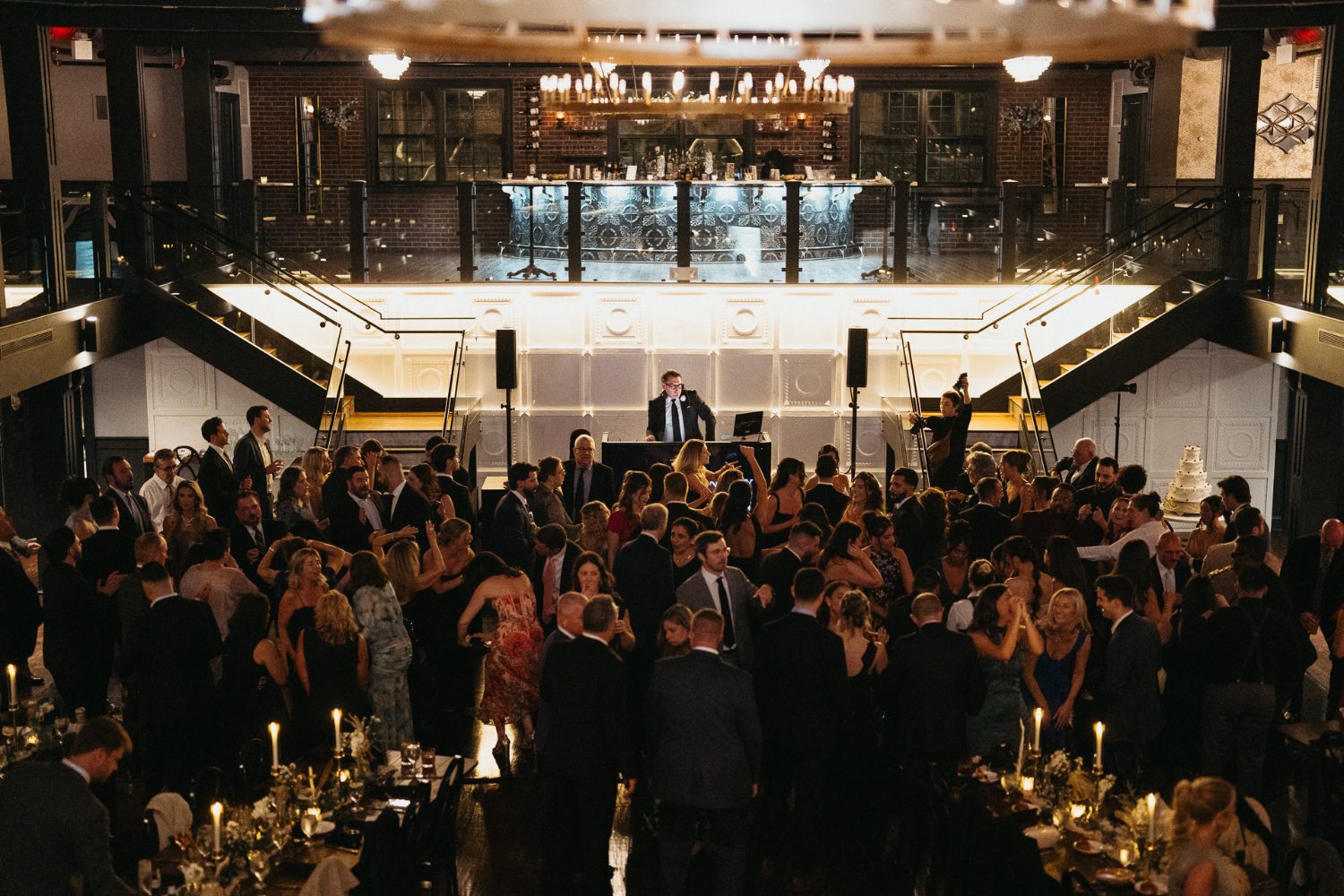 Wide view of a wedding reception from the staircase