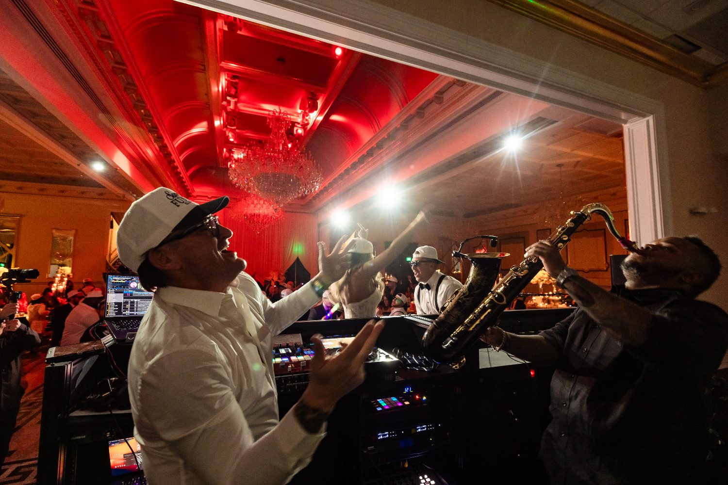 Jason Jani with a live horn player under red light